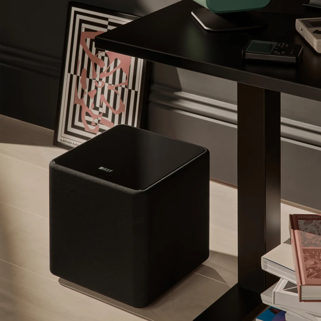 KEF Kube 8 MIE Black subwoofer placed in a living room setup