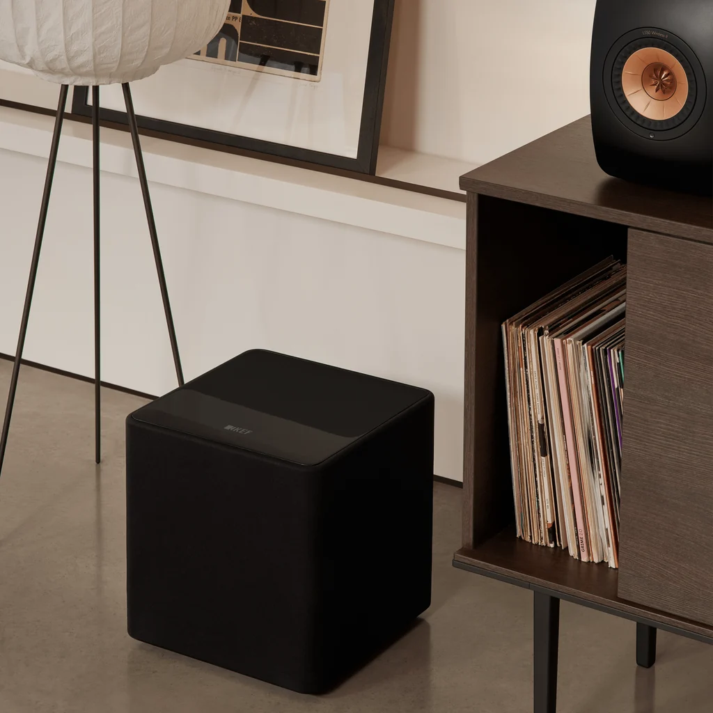 KEF Kube 10 MIE Black subwoofer placed in a living room setup