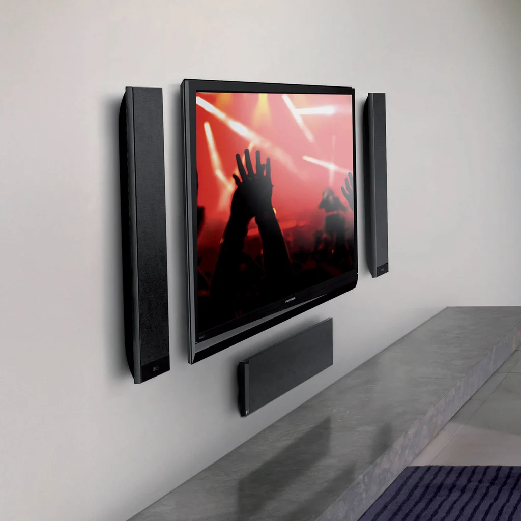 KEF T301c White centre channel speaker set up below a TV