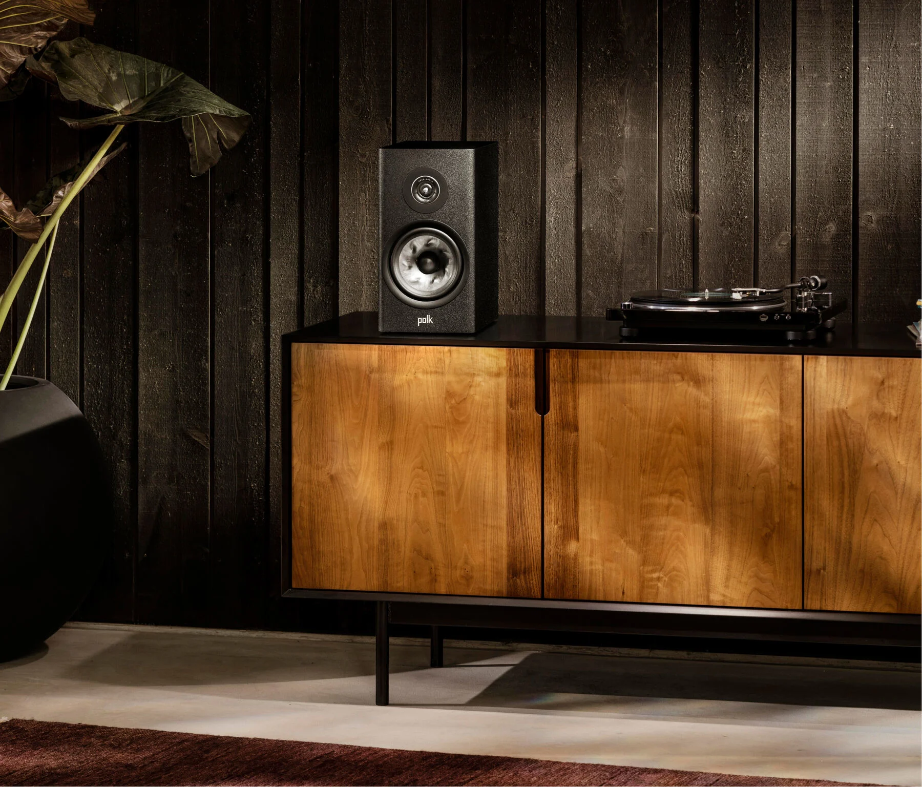 Polk Reserve R200 Black speakers on stands in a living room